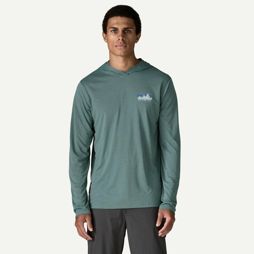 Man wearing sage green Patagonia hooded long-sleeve shirt on white background