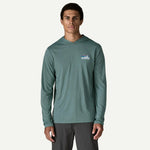 Man wearing sage green Patagonia hooded long-sleeve shirt on white background