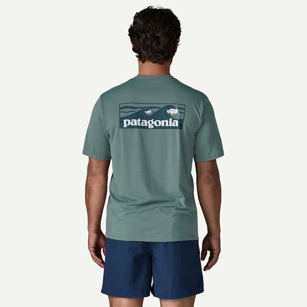 Back view of man wearing Patagonia sage green t-shirt with logo
