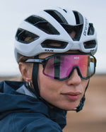 White Kask Protone Icon cycling helmet worn by cyclist with colorful sport sunglasses