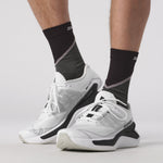 Salomon DRX Bliss running shoes in white and black colorway on model's feet