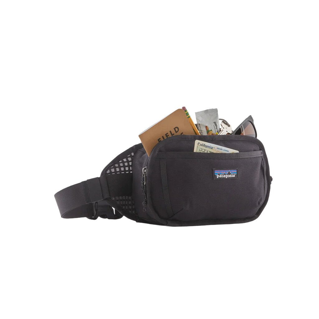 Black Patagonia Fieldsmith Hip Pack 5L with items stored in compartments