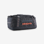 Patagonia Black Hole duffel bag in ink black with orange logo on clean background