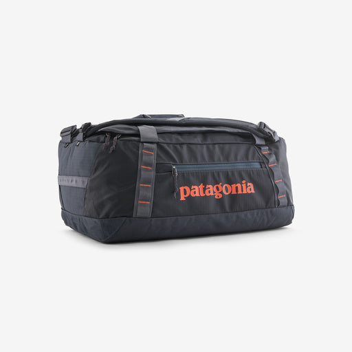 Patagonia Black Hole duffel bag in ink black with orange logo on clean background