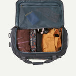 Interior view of open Patagonia Black Hole 40L duffel bag packed with clothing and gear, showing mesh lid pocket