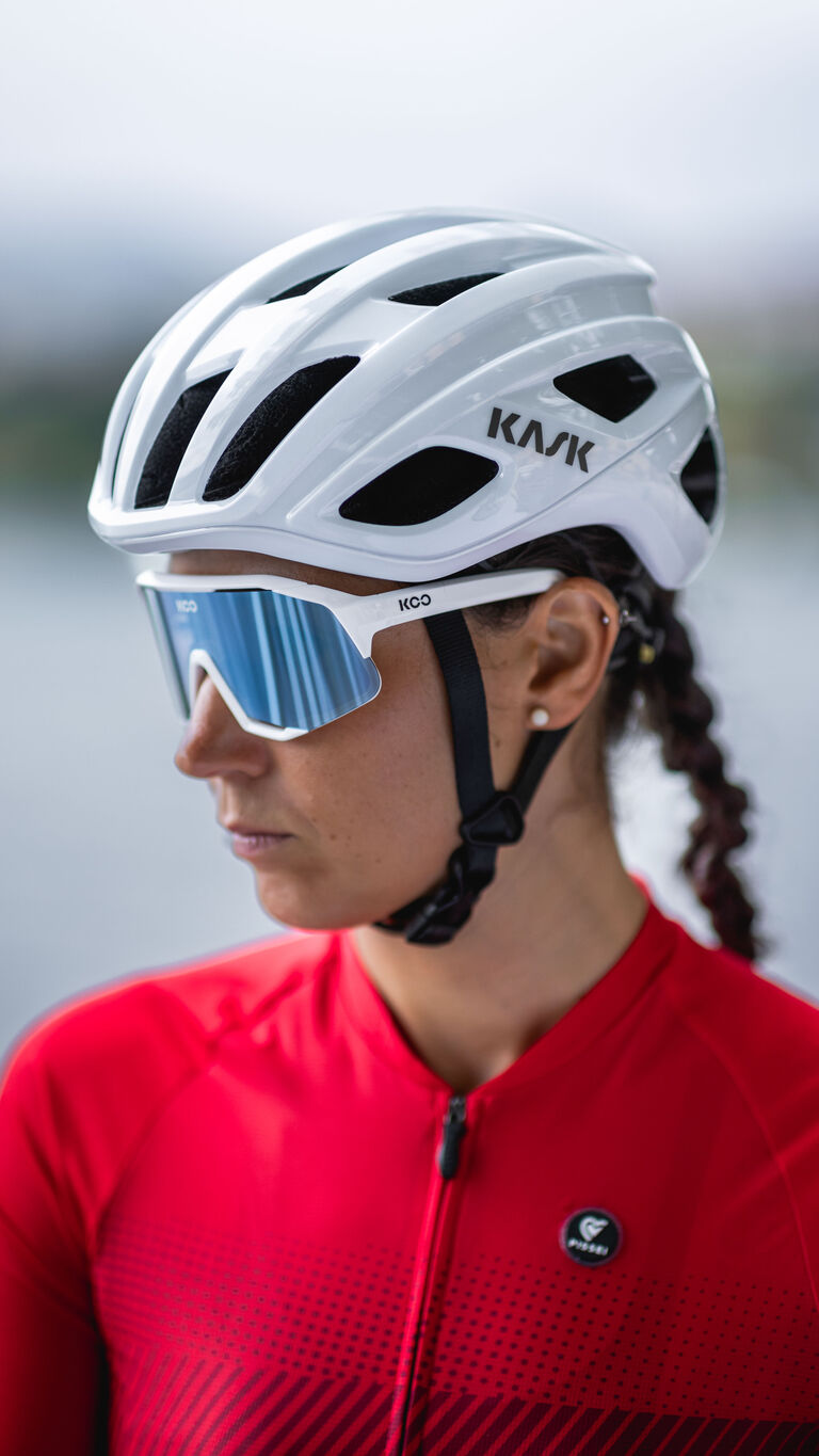 KASK Mojito Cubed helmet in white/grey worn by cyclist with blue sunglasses