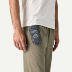 Patagonia Terravia Mini Hip Pack in patchwork gumtree green shown packed in navy stuff sack