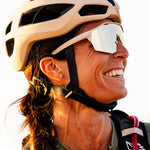 Woman wearing KOO Alibi cycling sunglasses in sand matt finish with helmet
