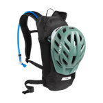 CamelBak Lobo black hydration backpack with green cycling helmet attached