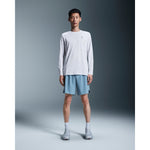 Man wearing white On Core Long-T shirt with light blue shorts