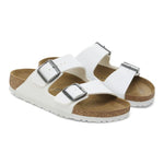 White Birkenstock Arizona two-strap sandals with buckles on clean background