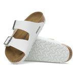 White Birkenstock Arizona sandals with dual buckle straps and cork footbed