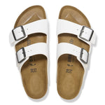 White Birkenstock Arizona sandals with two adjustable buckle straps on clean background