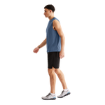 Man wearing black On Focus shorts with blue tank top in studio setting
