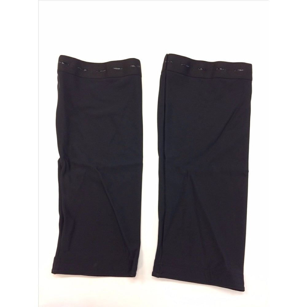Pair of black knee warmers laid flat on white background