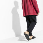 Black Birkenstock Boston clogs with ankle strap worn by model