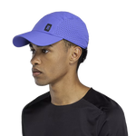 On Lightweight Unisex Cap in purple with perforated ventilation worn by male model
