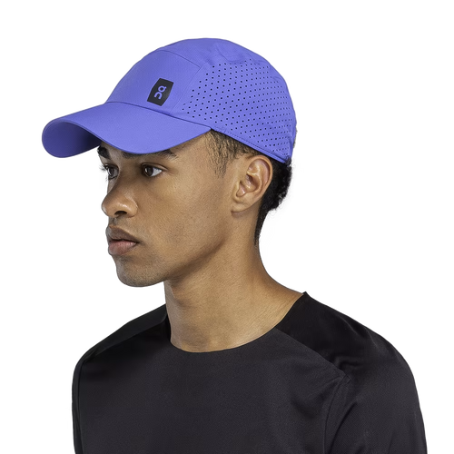 On Lightweight Unisex Cap in purple with perforated ventilation worn by male model