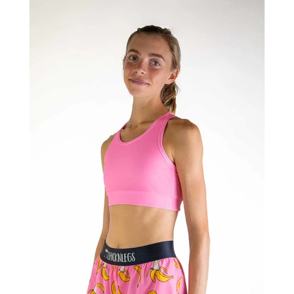 Woman wearing pink sports bra and matching patterned shorts with banana print