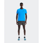 Man wearing dark gray On 5 inch performance shorts in studio setting