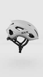 KASK Mojito Cubed white cycling helmet with ventilation holes and black straps