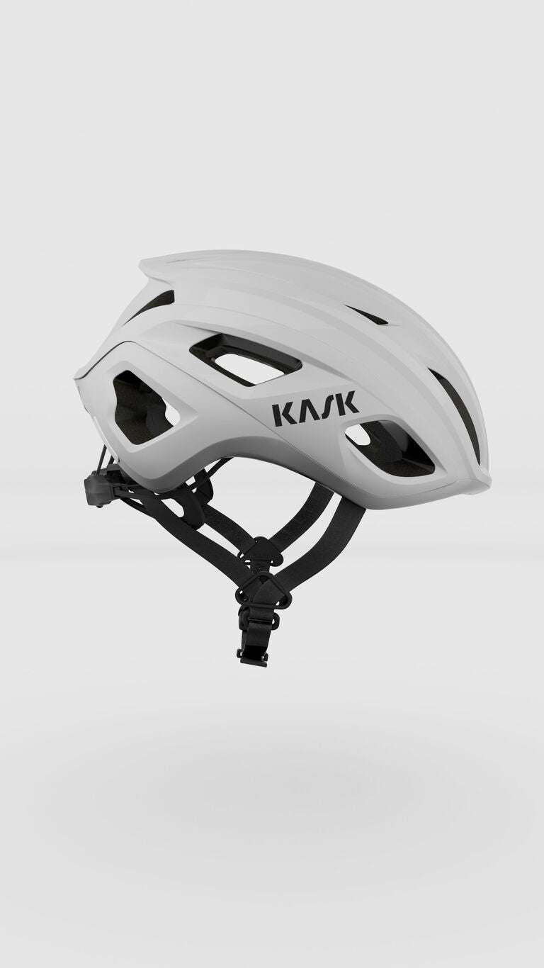 KASK Mojito Cubed white cycling helmet with ventilation holes and black straps
