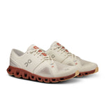 On Cloud X 3 running shoes in ice and auburn colorway on white background