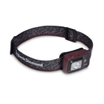 Black Diamond Astro headlamp with heathered gray strap and burgundy light housing