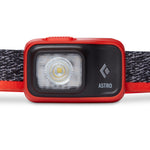Black Diamond Astro headlamp in red/orange octane color with LED light visible