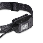 Black Diamond Astro 300-R headlamp in graphite with charging cable on white background