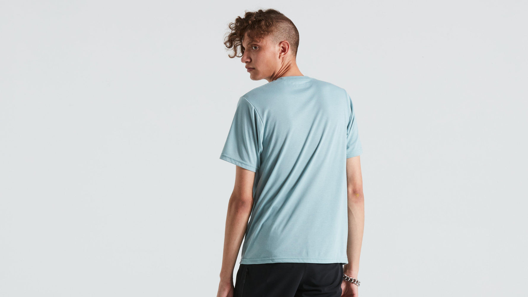 Man wearing light blue Specialized short sleeve t-shirt against white background