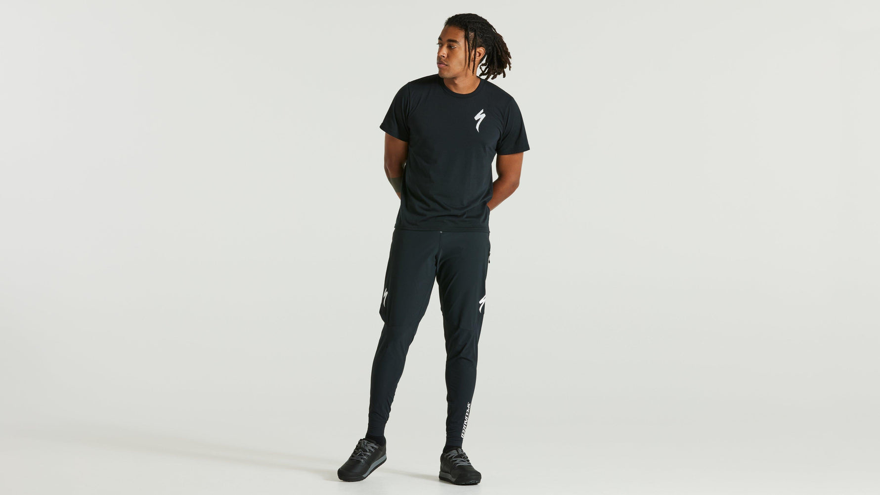 Man wearing dark green Specialized t-shirt and matching athletic pants with logo