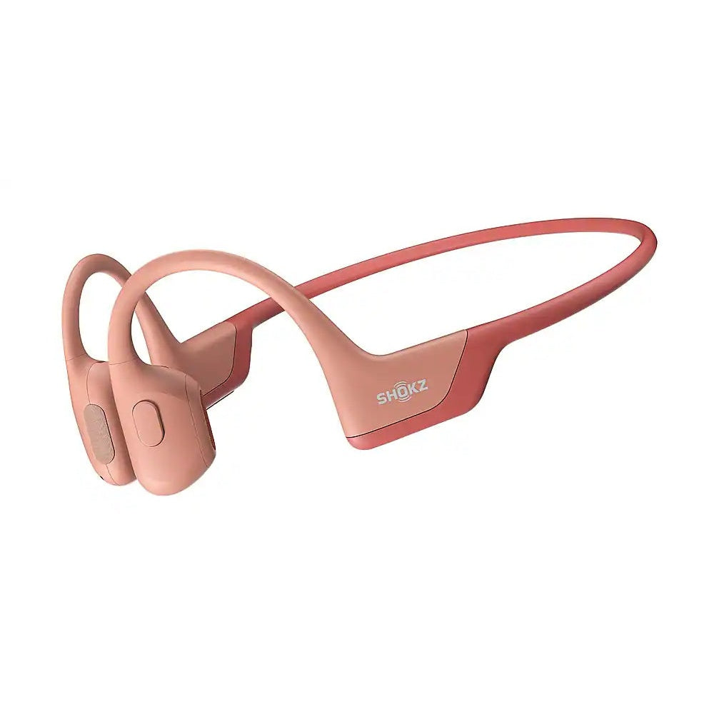 Shokz OpenRun Pro bone conduction headphones in pink coral color on white background
