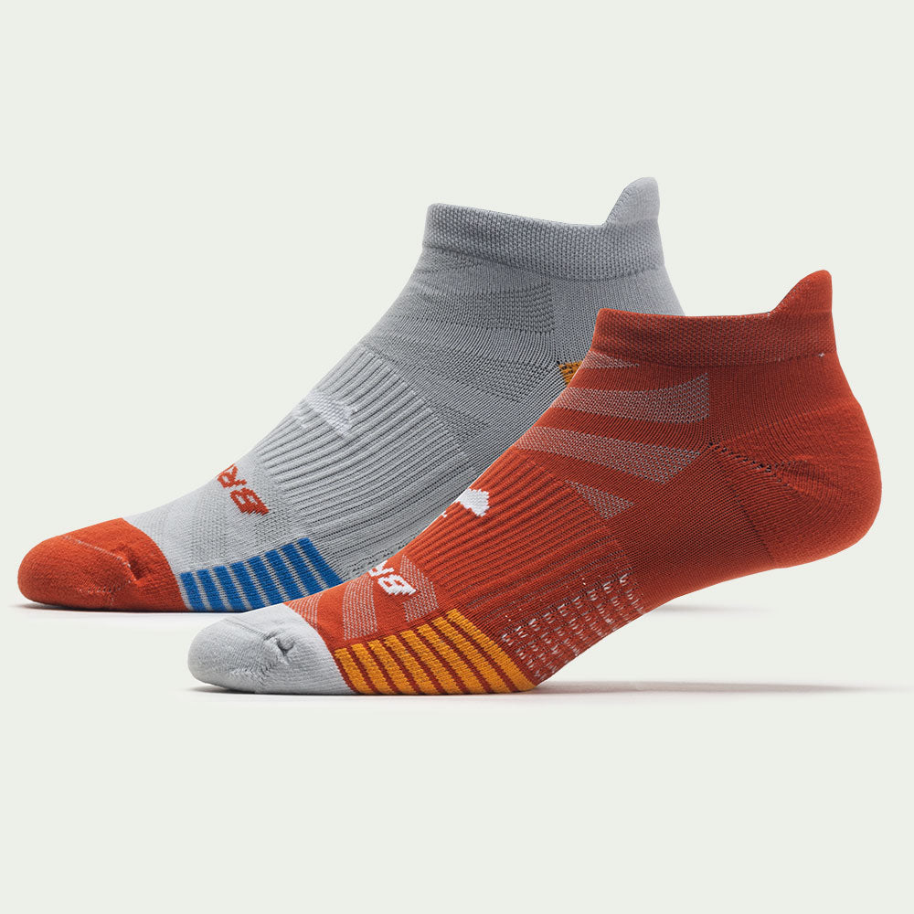 Two Brooks Ghost Lite athletic socks in gray and red colorways with striped details