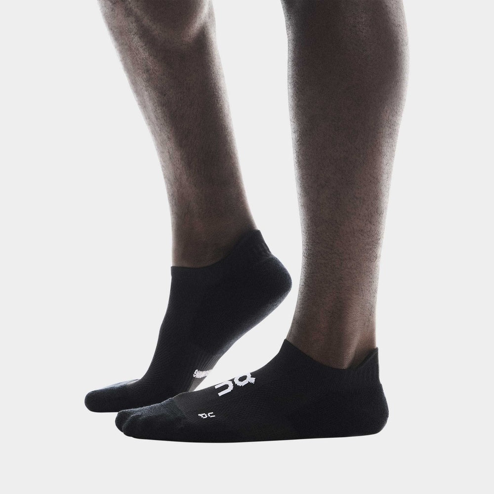 Black On Core Run Low socks worn on feet against clean white background