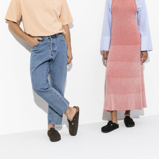 Two people wearing black Birkenstock Boston clogs in professional studio setting