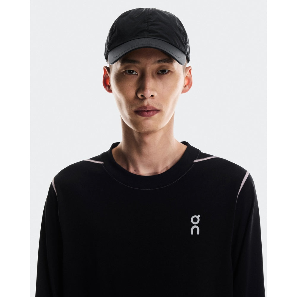 Model wearing On Cap Unisex in black with matching black long-sleeve top