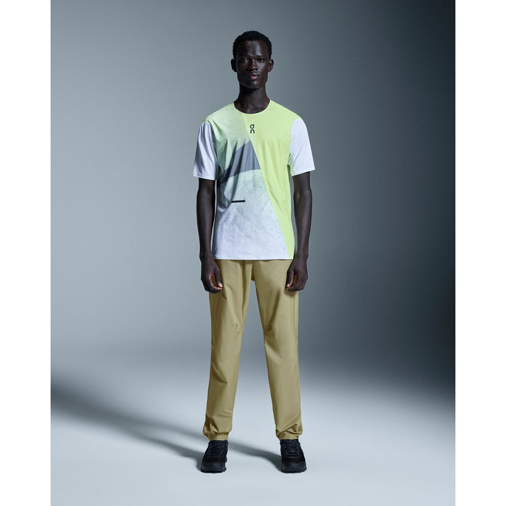 Male model wearing On Ultra Pants in Creek color with neon green On t-shirt