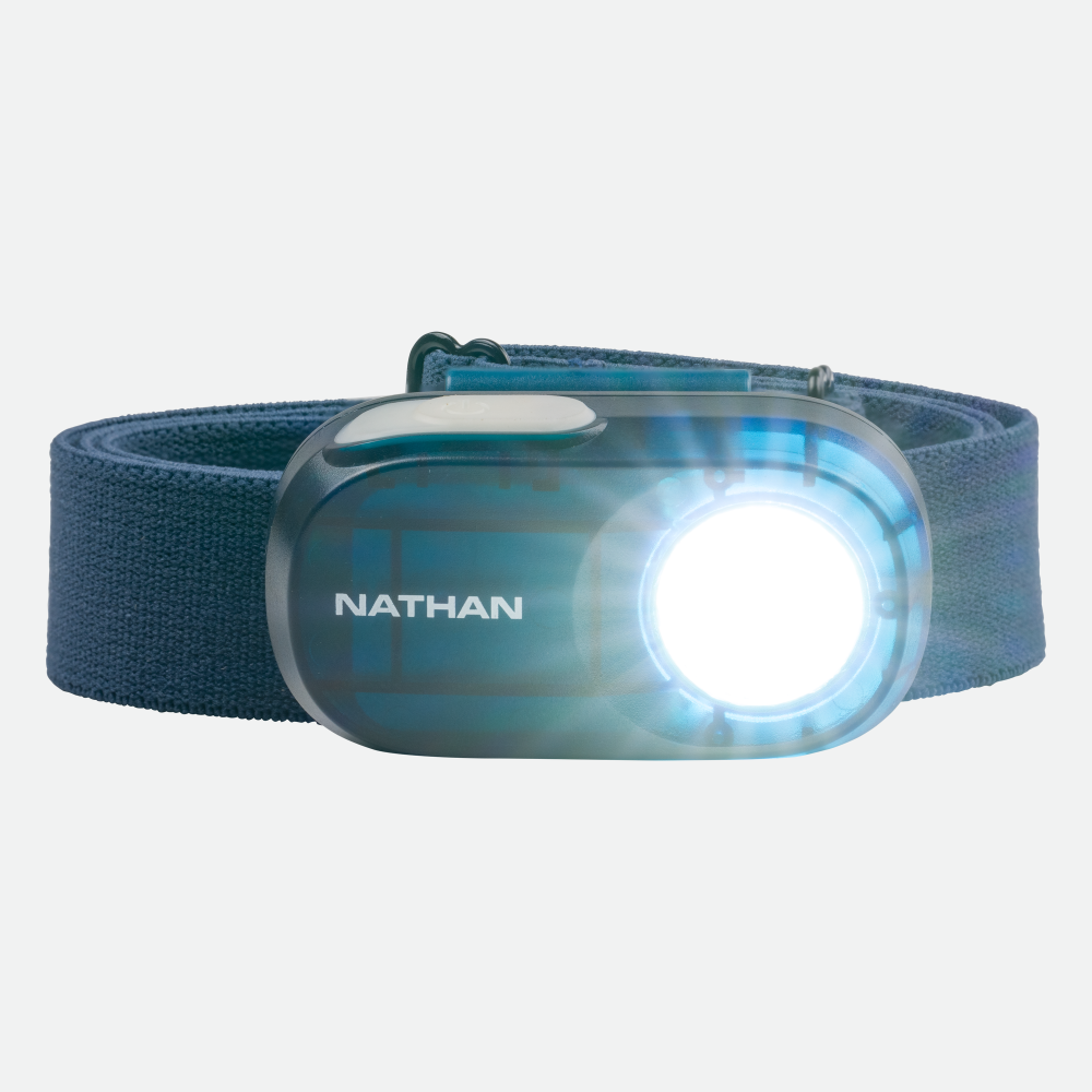 Nathan Luna Fire LED headlamp with blue strap and illuminated light on clean background