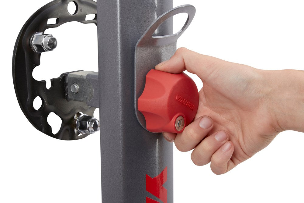 Hand operating red locking mechanism on Yakima SpareRide hitch rack