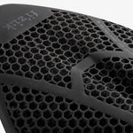Close-up of black Fizik bicycle saddle showing hexagonal ventilation pattern and brand logo