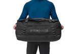 Person holding black Patagonia Black Hole Duffel 70L bag with handles