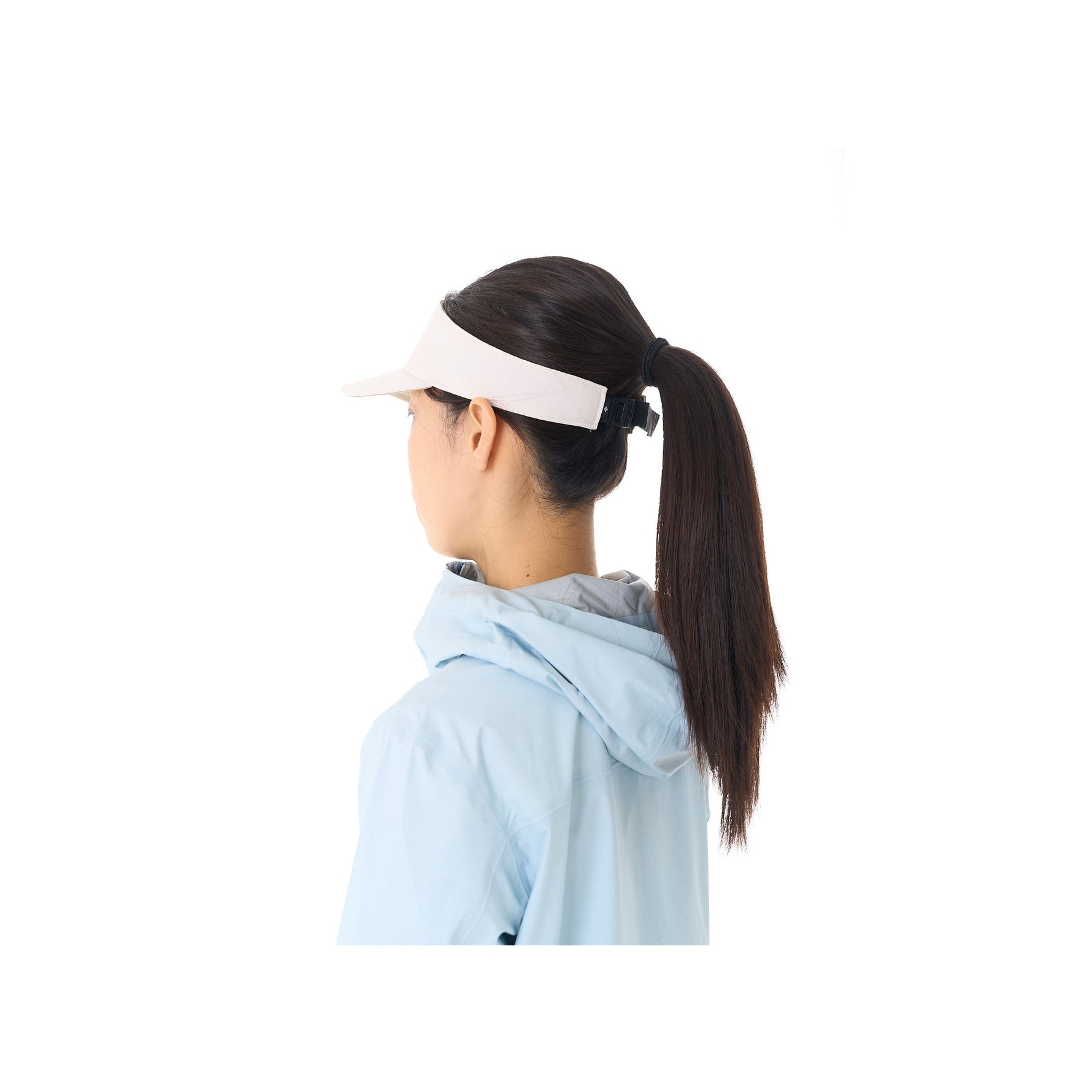 Woman wearing white Black Diamond Distance Visor with clean studio background