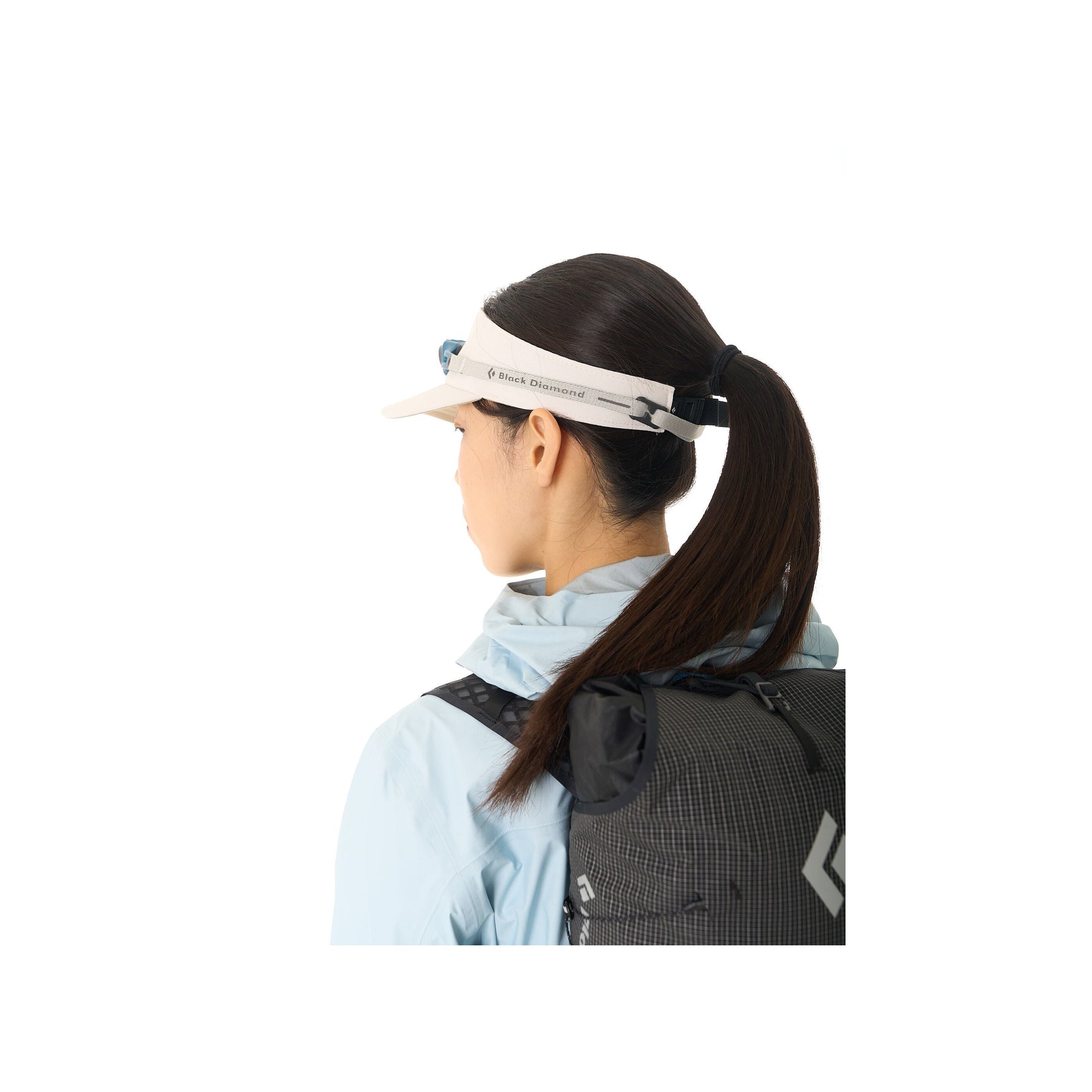 Woman wearing white Black Diamond Distance visor with clean studio background