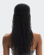 Woman wearing black On Lightweight Unisex Cap with long curly hair