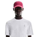 Model wearing pink On Lightweight Unisex Cap with white athletic shirt