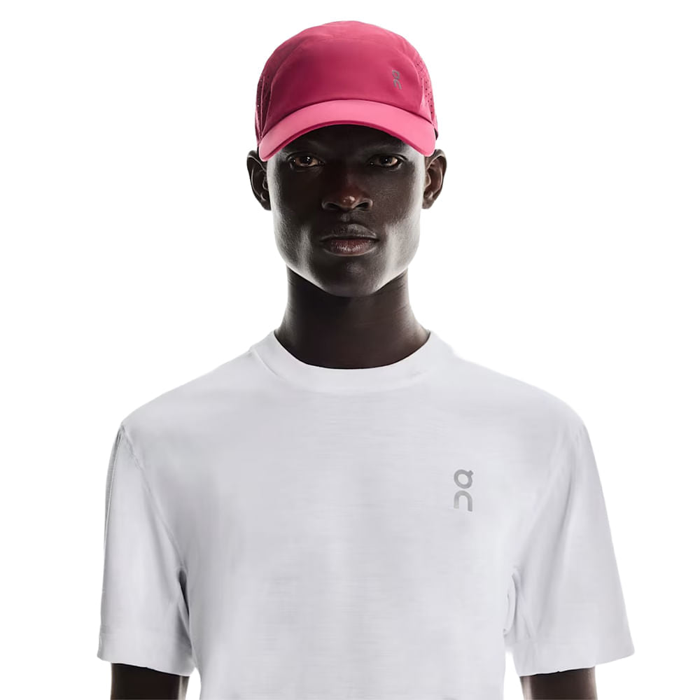 Model wearing pink On Lightweight Unisex Cap with white athletic shirt