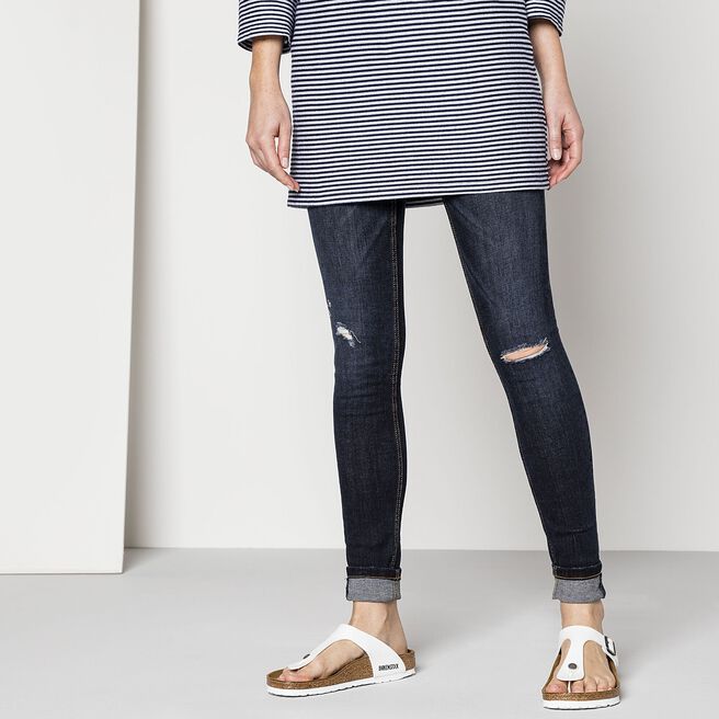 White Birkenstock Gizeh sandals worn with jeans and striped top