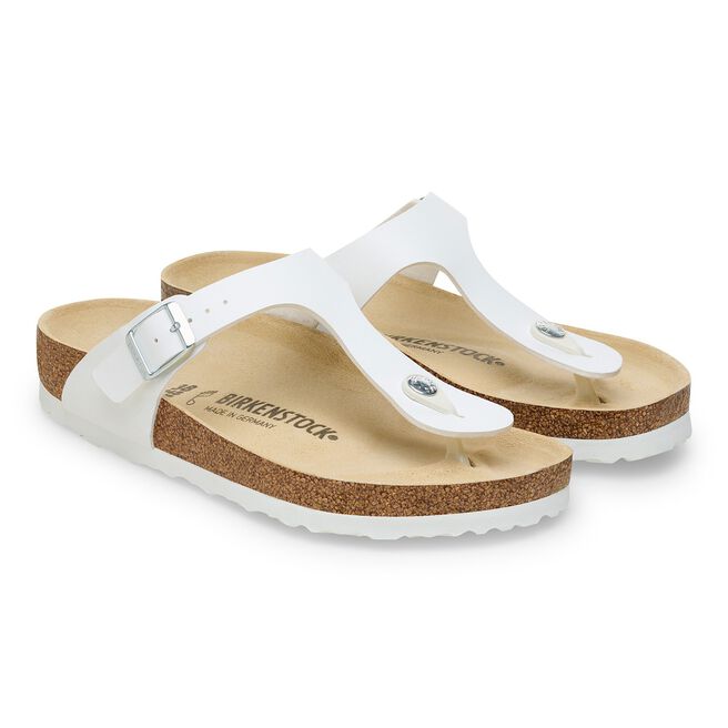 White Birkenstock Gizeh thong sandals with cork footbed and adjustable strap