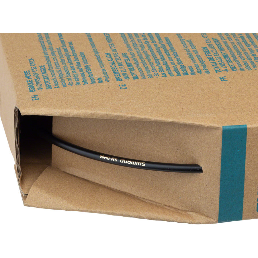 Shimano SM-BH90 black disc brake hose pulling out of workshop dispenser box opening